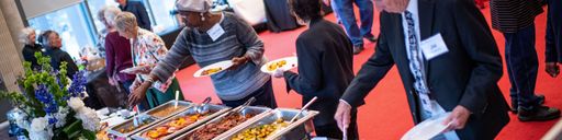 Folks filling their plates with delicious breakfast foods at the Retiree Brunch 2022