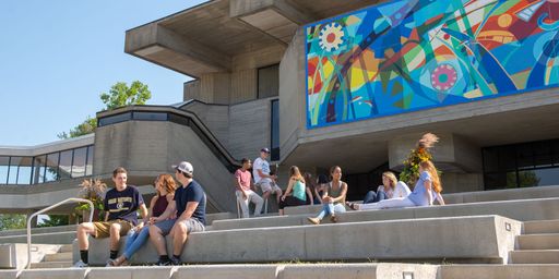Students sitting on the steps outside of the Campus Center