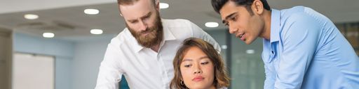 Business colleagues helping another with paperwork.