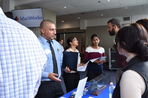 Vendors talking to students at a career fair