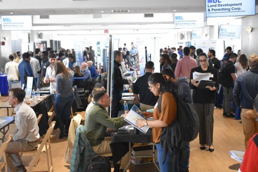 Students visiting tables at a career fair