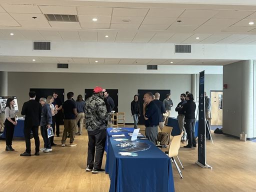Students speaking to vendors at a hiring event