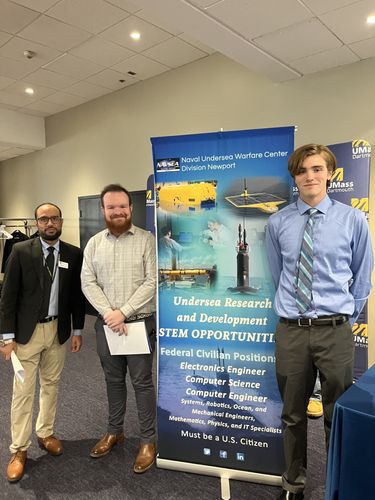 Student standing with representatives from the Naval Undersea Warfare Center