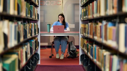 A student sitting working in the library.