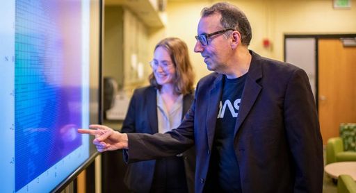 Professor Robert Fisher and Physics student McKenzie Ferrari discussing research in the Center for Scientific Computing and Data Science Research