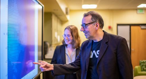 Professor Robert Fisher and Physics student McKenzie Ferrari discussing research in the Center for Scientific Computing and Data Science Research