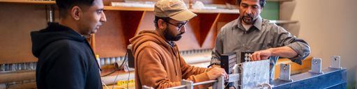 Professor Vijaya Chalivendra engaged in lab activity with his research team