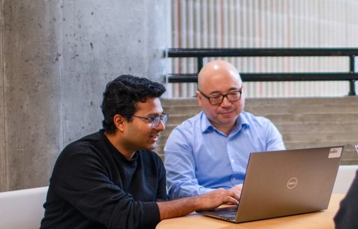 Student and faculty working at a computer together