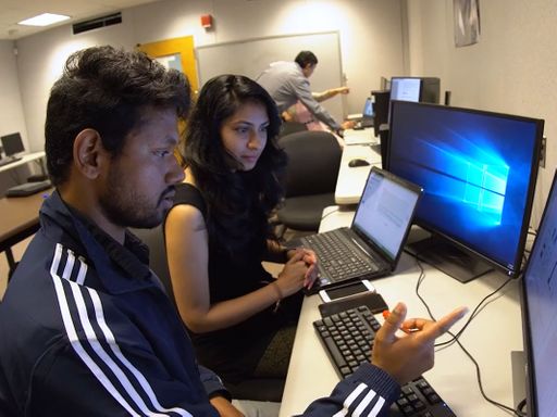 Engineering students collaborating on a project at a computer.