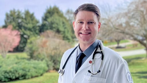 Standing on lawn in lab coat with stethoscope
