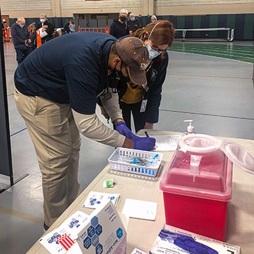 Dean Kimberly Christopher at COVID Clinic at Dartmouth High School with Daishawn Barros '22