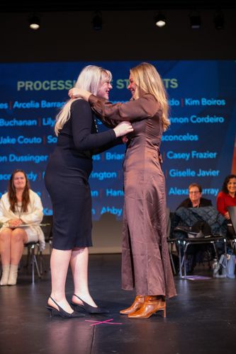 ABSN graduate being pinned on stage.