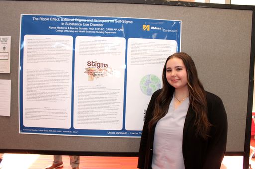 Nursing student with her research poster at the 2026 Scholarship Day