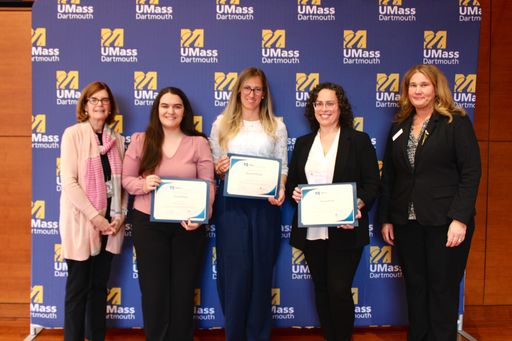 Nursing students posing with their awards along with nursing faculty