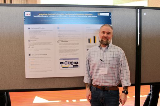 Nursing student with his research poster at the 2026 Scholarship Day