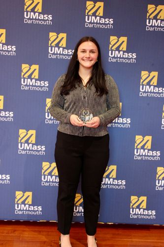 Nursing student posing with their Scholarship Day 2026 award