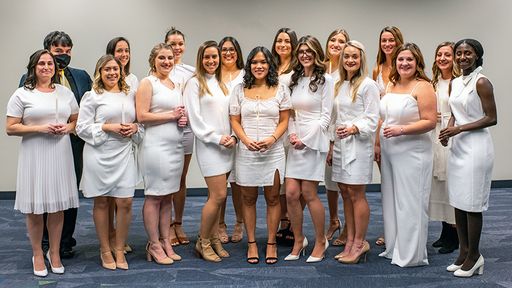 Nursing students holding candles before Pinning Ceremony
