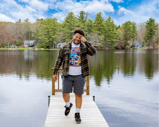 Marcus Howard '19 poses in front of a lake.