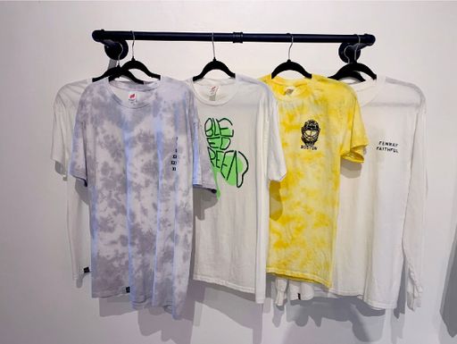 Wall Hanger, 2022, hanging exhibition t-shirts on mounted wall rack