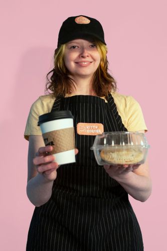 Café Uniform Photography, 2023, Bridget Landgren modeling a Kitty Corner hat and apron that I digitally embroidered 5.5 x 8.3 in.