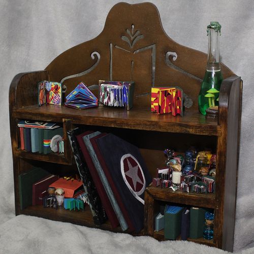 A Collection of Collection Shelf, 2023, Handmade shelf with handmade knickknacks. Books made from collections of close people in Lilly’s life. 18.5 x 22.5 in.