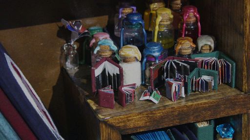 Tiny Potion Collection, 2023, Potions made from found things and given interesting names. Sealed with wax and string. One-inch books and smaller ones also featured.