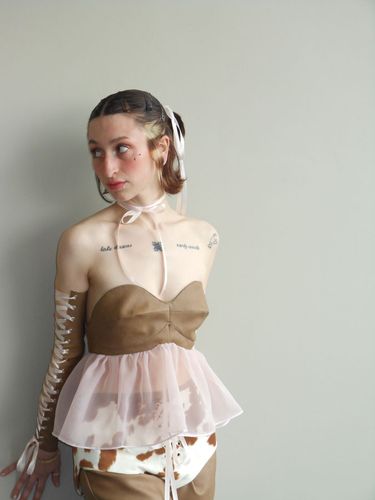 Look 4, 2026, strapless brown bodice with sheer pink peplum and lace up sleeve detail.