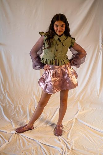 Look 1, 2026, army vest with ruffle peplum and flutter cap sleeves plus purple organza bishop sleeves paired with a pink metallic lamè tiered skirt.