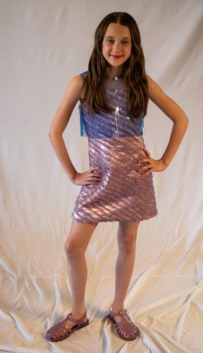 Look 2, 2026, pink metallic lamè sheath dress with allover purple shredded organza strips, paired with a blue vinyl t-shirt.