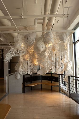 Enmeshed, 2022, clay slip, cheese cloth, glue, led lights, wire, string, ~9’ x 10’ x 5’