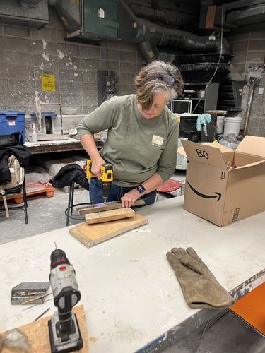 Mary Lou Nicholson who collected all the bottles with her group beach cleanups called Be the Solution to Pollution, drills holes in some of the 30,000 bottles