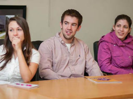 3 students at an Enactus weekly meeting in 2012