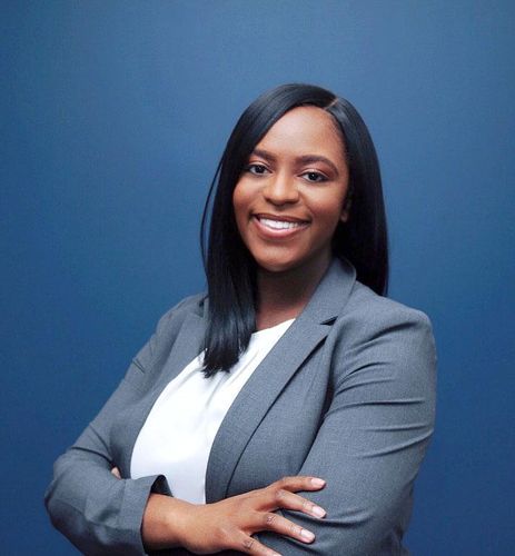 Laurie Senat, JD '21 standing with arms folded