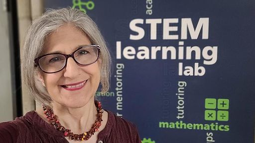 Chris Peter standing in front of the STEM learning lab sign