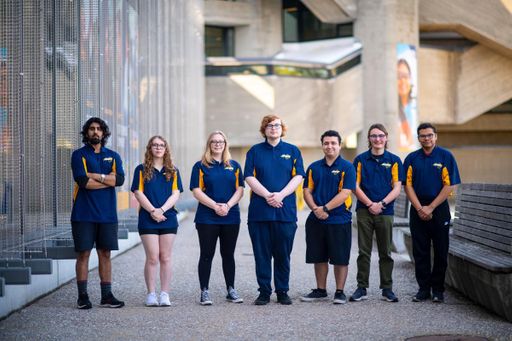 Students in the Engineering Ambassadors group standing in a row outside the library