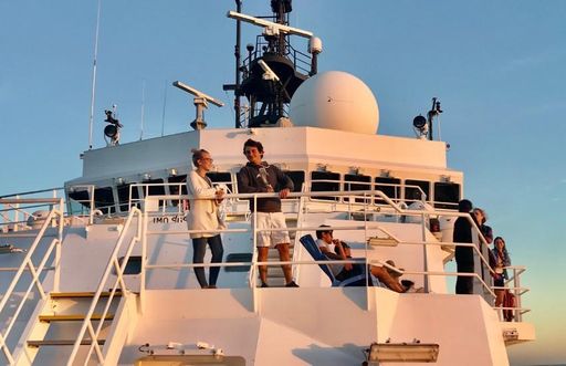 Juan and fellow researchers on research vessel at sunset