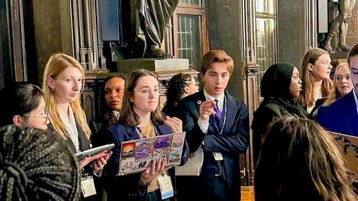 Kach (center) leading a working group with other delegates at the NMUN Germany conference.