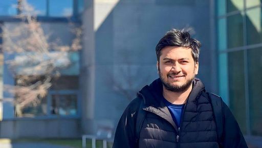 Rahul Chaube stands outside the Charlton College of Business