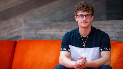 Christopher Brunette sitting in the library