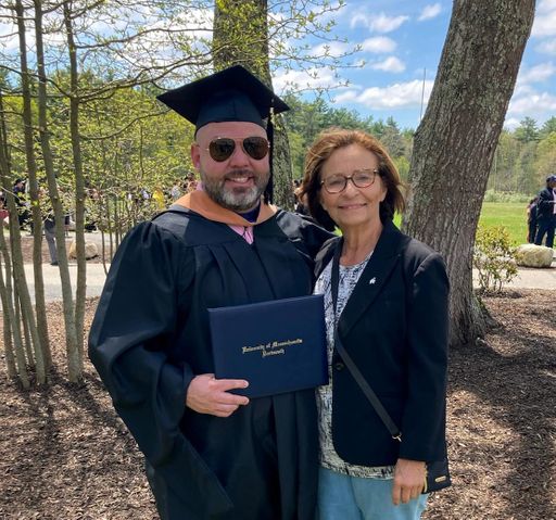 Giesta poses with his mother at commencement.