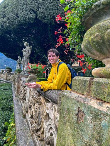 Devon Zapor '24 in his admissions ambassador jacket at Villa Balbianello on Lake Como, Italy – the location that portrayed 