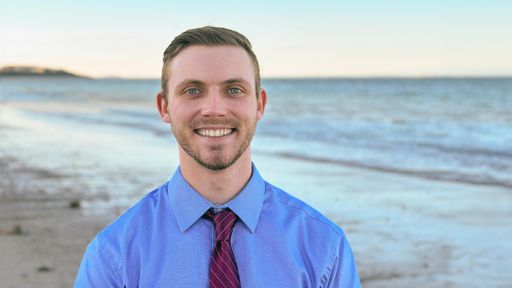 Seth Shea standing in front of the ocean