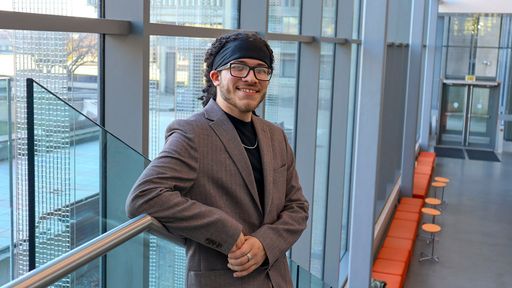 Tam Carter smiling, standing in the library