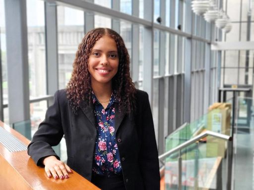 Cybersecurity student Raquel Bush stands in the UMassD library