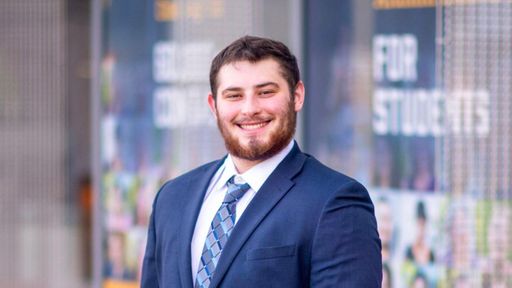Management major Collin Farr pictured outside the Claire T. Carney Library
