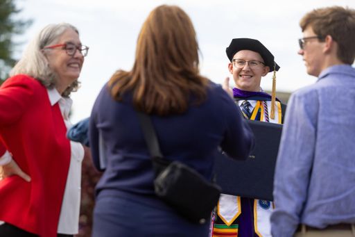 Sean Perrine pictured on the campus quad following the commencement ceremony.