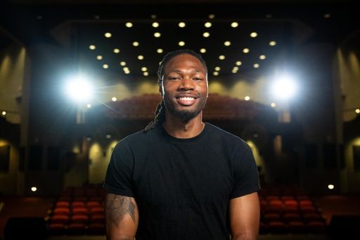 Sam Riley pictured seated in the campus auditorium.
