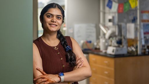 Anushka Sharma standing in the lab smiling