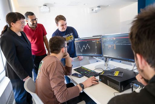 Professor Chan Du with students in the Charlton Technology Center, including Dheeraj Reetha Venugopalan MBA '23 (red shirt)