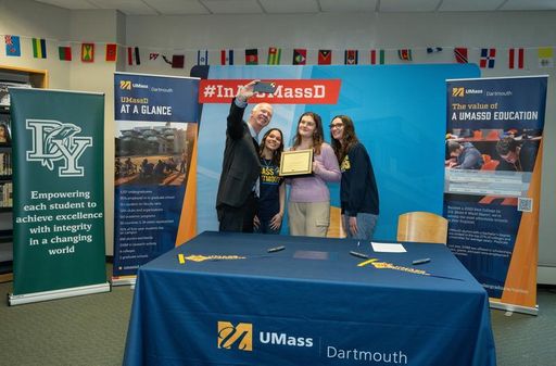 Chancellor Fuller taking a photo with Molly Gedutis and 2023 Scholars